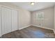 Bedroom with a large closet, neutral paint, a bright window and wood-look floors at 4931 Galax Dr, Charlotte, NC 28213