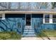 Close-up of a classic blue brick home with a black front door and matching railings at 4931 Galax Dr, Charlotte, NC 28213