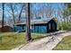 View of the home's exterior, featuring new paint, driveway, and grass at 4931 Galax Dr, Charlotte, NC 28213