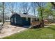 View of the home's exterior, featuring a deck, new paint, and grass at 4931 Galax Dr, Charlotte, NC 28213
