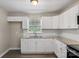Updated kitchen featuring modern white cabinets, granite counters, and subway tile backsplash at 4931 Galax Dr, Charlotte, NC 28213