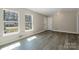 Bright living room with large windows and modern gray wood flooring at 4931 Galax Dr, Charlotte, NC 28213