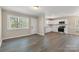 Open concept living room and kitchen with bright walls, sleek floors, and double windows at 4931 Galax Dr, Charlotte, NC 28213