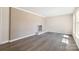 Inviting living room featuring gray wood floors and a neutral brick fireplace at 4931 Galax Dr, Charlotte, NC 28213