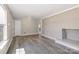 Spacious living room with gray wood floors, brick fireplace, and ample natural light at 4931 Galax Dr, Charlotte, NC 28213