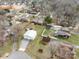 An aerial view of a residential neighborhood showing a mix of houses, trees, and open spaces at 5412 Carving Tree Dr, Harrisburg, NC 28075