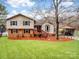 Charming two-story home with a well-maintained lawn, colorful mulch, and mature trees in a residential neighborhood at 5412 Carving Tree Dr, Harrisburg, NC 28075