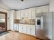 Bright kitchen featuring white cabinetry, granite countertops, stainless steel appliances, and hardwood flooring at 5412 Carving Tree Dr, Harrisburg, NC 28075