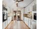 Bright kitchen featuring white cabinetry, granite countertops, stainless steel appliances, and hardwood flooring at 5412 Carving Tree Dr, Harrisburg, NC 28075