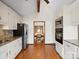 Bright kitchen featuring white cabinetry, granite countertops, stainless steel appliances, and hardwood flooring at 5412 Carving Tree Dr, Harrisburg, NC 28075