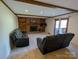 Cozy living room featuring a brick fireplace, wood beams, and sliding door to deck at 5412 Carving Tree Dr, Harrisburg, NC 28075