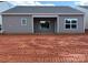 View of the home's back exterior with siding, windows and a covered patio area at 5708 Skinny Dr, Charlotte, NC 28215