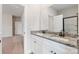 Bathroom with a dual sink vanity with granite countertops and a walk-in shower at 5708 Skinny Dr, Charlotte, NC 28215