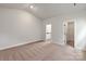 Bright bedroom with neutral tones, carpeted floors, and easy access to the Primary bathroom at 5708 Skinny Dr, Charlotte, NC 28215