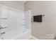 Clean, well-lit bathroom showcases a bathtub with wall shelving at 6615 Buck Horn Pl, Waxhaw, NC 28173