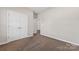 Carpeted bedroom with view to another room and a double-doored closet at 6615 Buck Horn Pl, Waxhaw, NC 28173
