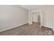 Carpeted bedroom featuring french doors and view into hallway and closet at 6615 Buck Horn Pl, Waxhaw, NC 28173