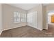 Carpeted bedroom featuring a double window, closet and view into the hall at 6615 Buck Horn Pl, Waxhaw, NC 28173