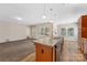 Kitchen with an island, modern flooring, view to the living area with natural light, and ample counter space at 6615 Buck Horn Pl, Waxhaw, NC 28173