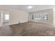 Open living room space with neutral color palette and many windows at 6615 Buck Horn Pl, Waxhaw, NC 28173