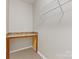 Walk-in closet features custom shelving and built in desk area, offering ample storage and organization space at 6615 Buck Horn Pl, Waxhaw, NC 28173