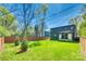 This backyard is spacious with lush green grass and a privacy fence at 805 E 19Th St, Charlotte, NC 28205