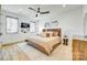 Cozy bedroom showcasing neutral tones, wooden headboard, decorative pillows, a ceiling fan and ample natural light at 805 E 19Th St, Charlotte, NC 28205