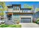 Contemporary two-story home with a gray exterior, fenced front porch, and a matching attached garage at 805 E 19Th St, Charlotte, NC 28205