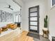 Bright foyer with wood floors, designer cactus, and black framed door leading into living area at 805 E 19Th St, Charlotte, NC 28205
