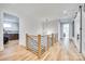 Upstairs hallway with natural light, hardwood floors, modern lighting, and stylish railing at 805 E 19Th St, Charlotte, NC 28205