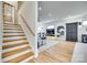 Bright living room with a modern staircase, hardwood floors, and a sleek entertainment center at 805 E 19Th St, Charlotte, NC 28205