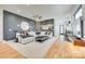 Stylish living room featuring a large sofa, dark accent wall, and hardwood floors at 805 E 19Th St, Charlotte, NC 28205