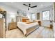 This main bedroom has a ceiling fan, hardwood floors and an ornate bed frame at 805 E 19Th St, Charlotte, NC 28205