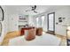 Bright home office featuring modern lighting, a large desk, and two leather chairs with access to a balcony at 805 E 19Th St, Charlotte, NC 28205