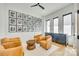 Cozy sitting room featuring wood floors, leather chairs, and a wall of framed artwork at 805 E 19Th St, Charlotte, NC 28205