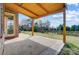 Covered back patio overlooking serene water feature and backyard at 8513 Garden View Dr, Charlotte, NC 28277