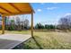 View of the peaceful backyard and covered patio area at 8513 Garden View Dr, Charlotte, NC 28277