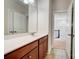 Bathroom features wood cabinets with white countertop, large mirror, and tile floor at 8513 Garden View Dr, Charlotte, NC 28277