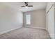 Bright bedroom features neutral walls, plush carpeting, and a window at 8513 Garden View Dr, Charlotte, NC 28277