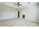 Large bedroom showcasing a tray ceiling and adjoining bathroom at 8513 Garden View Dr, Charlotte, NC 28277