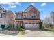 Charming brick two-story home with a well-manicured lawn and a two-car garage, creating curb appeal at 8513 Garden View Dr, Charlotte, NC 28277