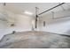 Spacious garage with concrete floor, overhead lighting, and ample storage shelving at 8513 Garden View Dr, Charlotte, NC 28277