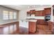 Spacious kitchen with an island and cherry wood cabinets, stainless steel appliances and hardwood floors at 8513 Garden View Dr, Charlotte, NC 28277