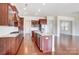 Well-lit kitchen features a large island with granite countertops and custom wood cabinets at 8513 Garden View Dr, Charlotte, NC 28277