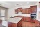 Open-concept kitchen features granite countertops, wood cabinets, and stainless steel appliances at 8513 Garden View Dr, Charlotte, NC 28277