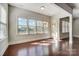 Bright living room featuring hardwood floors, large windows, and natural light at 8513 Garden View Dr, Charlotte, NC 28277
