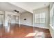 Open-concept living room featuring hardwood floors, ceiling fan, and bright natural light at 8513 Garden View Dr, Charlotte, NC 28277
