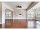Bright, open living room with hardwood floors, ceiling fan, and large windows at 8513 Garden View Dr, Charlotte, NC 28277