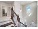 Staircase featuring stained wood treads, iron balusters, and large window at 8513 Garden View Dr, Charlotte, NC 28277