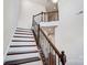 Dramatic staircase with stained wood treads and decorative iron balusters at 8513 Garden View Dr, Charlotte, NC 28277